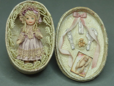 Doll in an oval box
